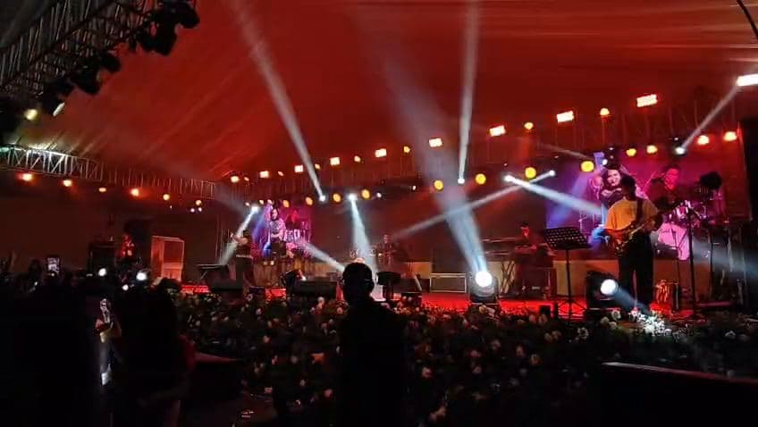 Red-lit concert stage with LED backdrop